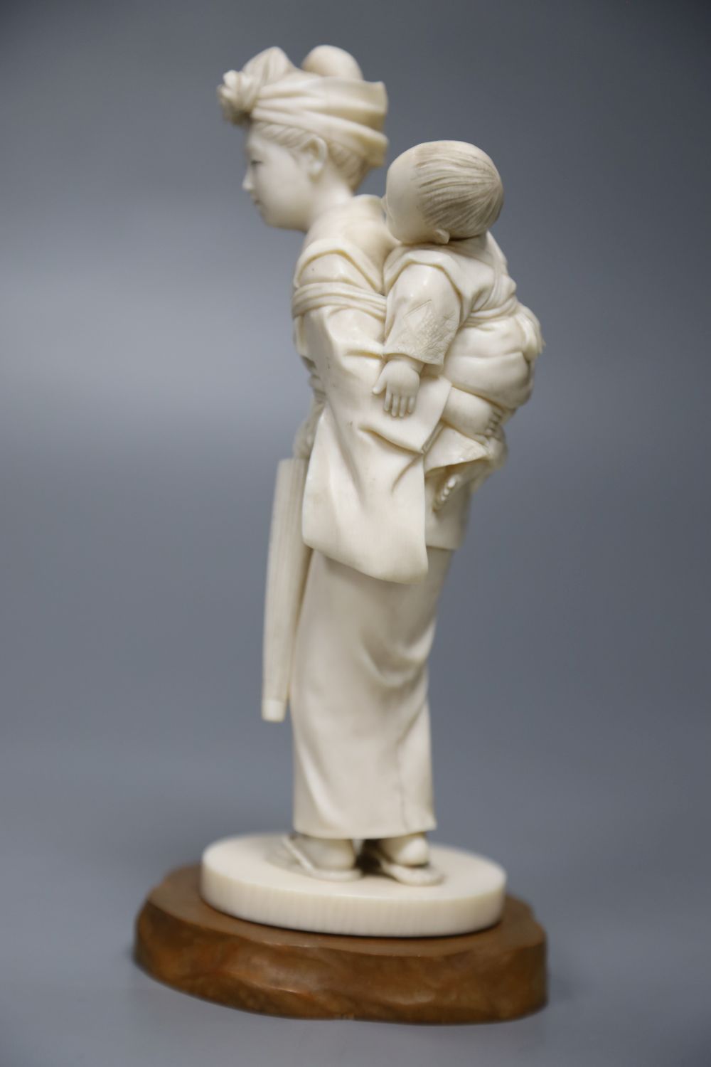 A Japanese carved ivory figure of a geisha and child, height 19cm